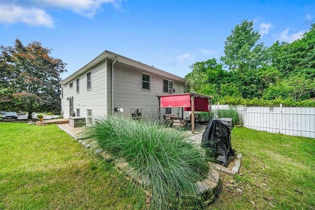 view of side of home with a yard