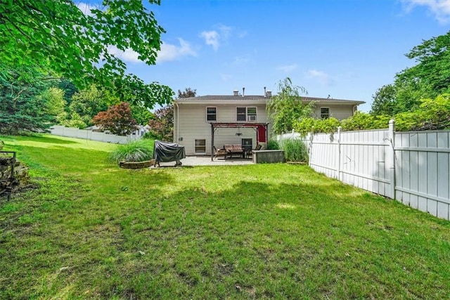 back of house featuring a yard, a pergola, and a patio