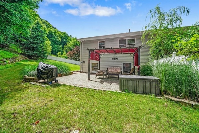 back of property featuring a patio, a pergola, and a lawn