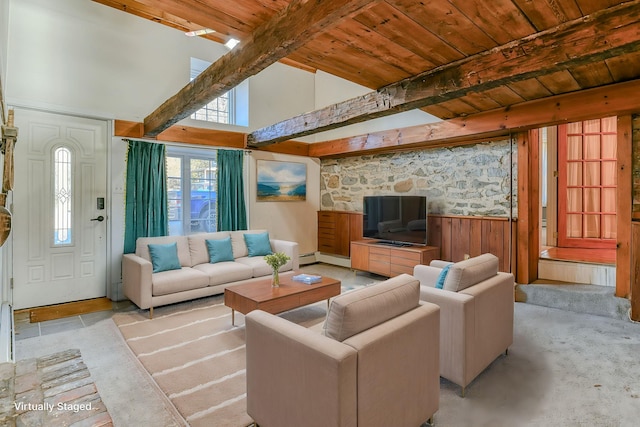 living room with beamed ceiling, wood ceiling, and wooden walls