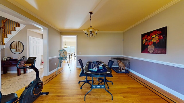 dining area featuring a notable chandelier, wood-type flooring, and crown molding