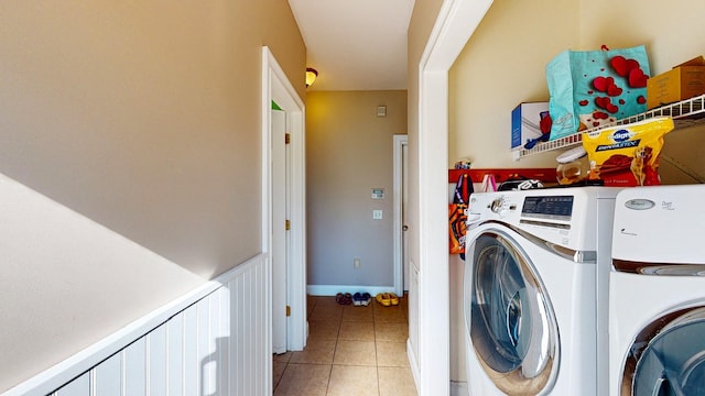 laundry room with tile patterned flooring and washing machine and clothes dryer