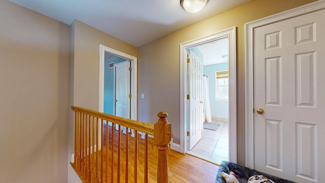 corridor with light hardwood / wood-style flooring