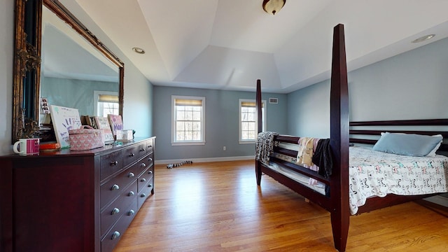 bedroom featuring light hardwood / wood-style flooring and vaulted ceiling