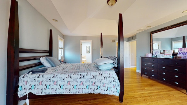 bedroom with multiple windows and light wood-type flooring