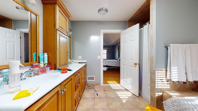 bathroom with vanity, tile patterned floors, and a healthy amount of sunlight