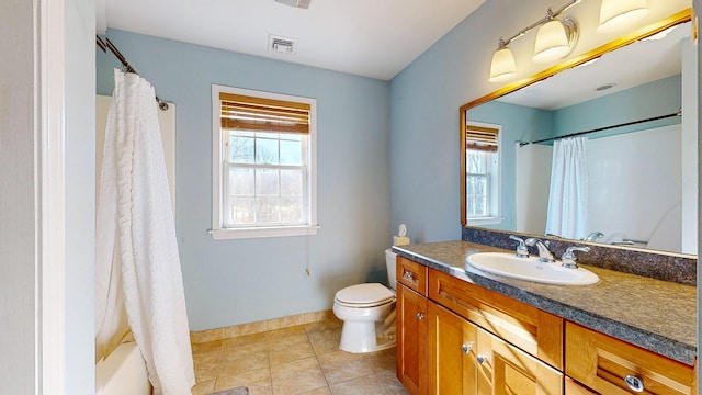 full bathroom featuring toilet, vanity, tile patterned floors, and shower / bathtub combination with curtain