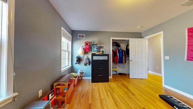 game room with light hardwood / wood-style flooring