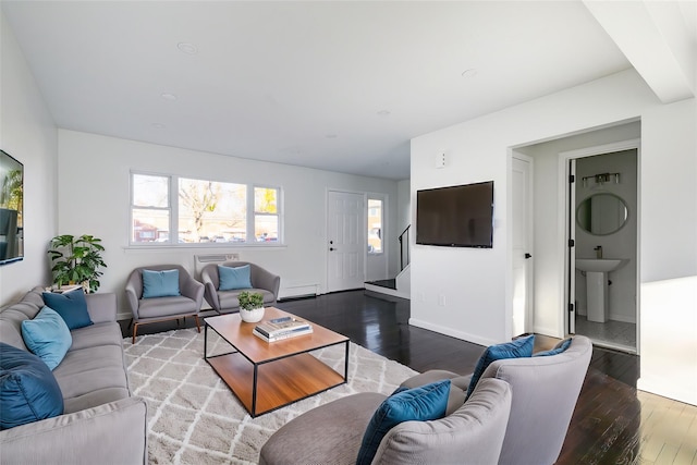 living room featuring wood-type flooring, sink, and a baseboard radiator