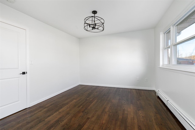 unfurnished dining area featuring dark hardwood / wood-style floors, a baseboard heating unit, and a notable chandelier