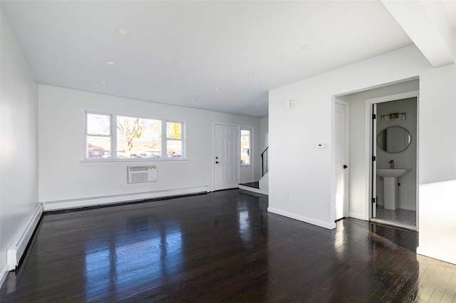 unfurnished living room featuring a wall mounted AC, sink, dark hardwood / wood-style floors, and a baseboard heating unit