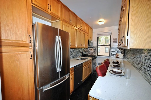 kitchen featuring sink, appliances with stainless steel finishes, and tasteful backsplash