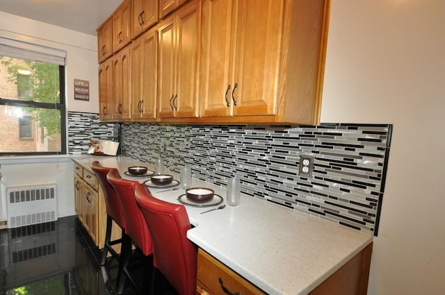 kitchen featuring backsplash and radiator