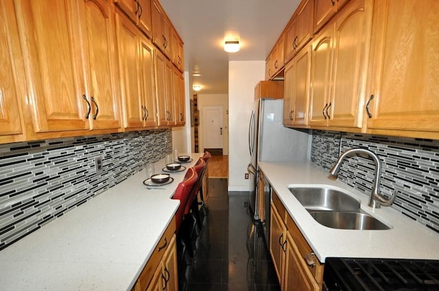 kitchen with range, tasteful backsplash, and sink