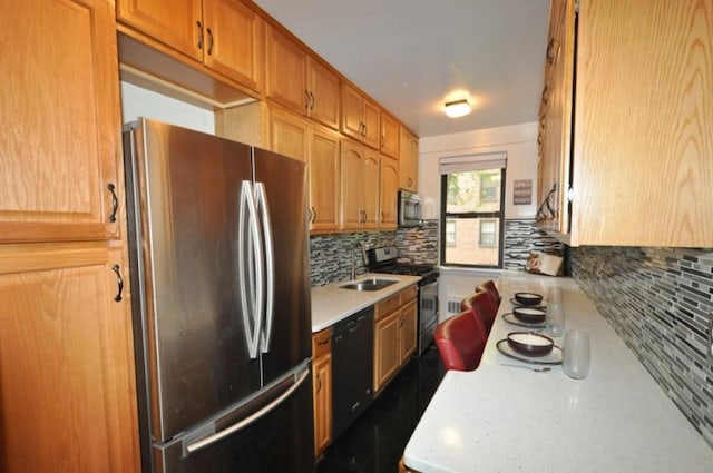 kitchen with black appliances, sink, and tasteful backsplash