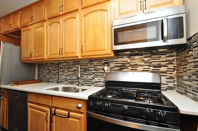 kitchen with sink, stainless steel appliances, and tasteful backsplash