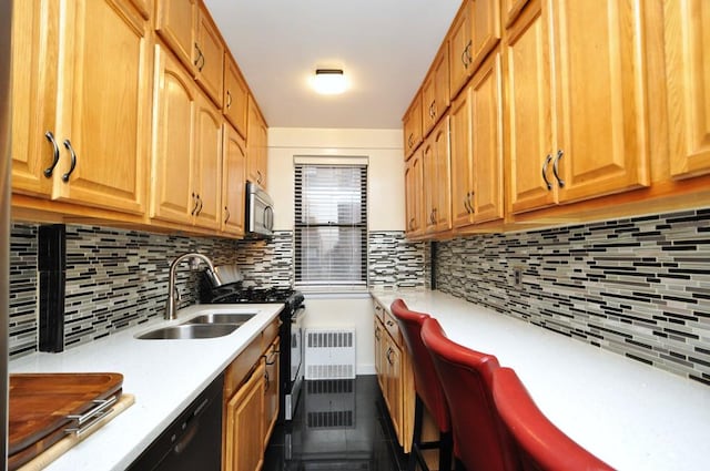 kitchen featuring gas stove, decorative backsplash, and sink