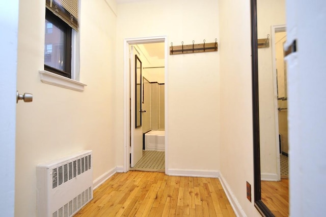 corridor featuring light hardwood / wood-style floors and radiator