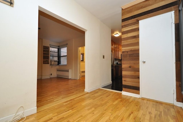 hall featuring light wood-type flooring and radiator