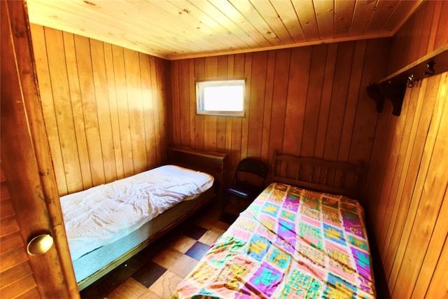 bedroom featuring wooden ceiling and wooden walls