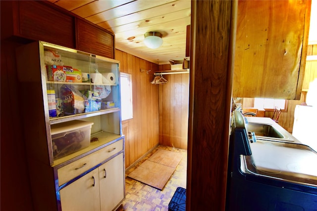 interior space with light parquet flooring, wooden ceiling, and wood walls