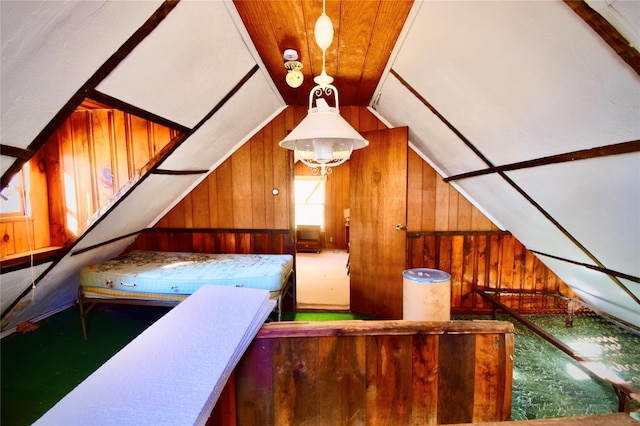 interior space featuring wooden walls, carpet floors, and lofted ceiling