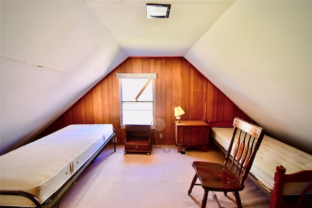 bedroom featuring wood walls and lofted ceiling