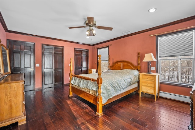 bedroom featuring visible vents, a baseboard radiator, crown molding, and wood finished floors