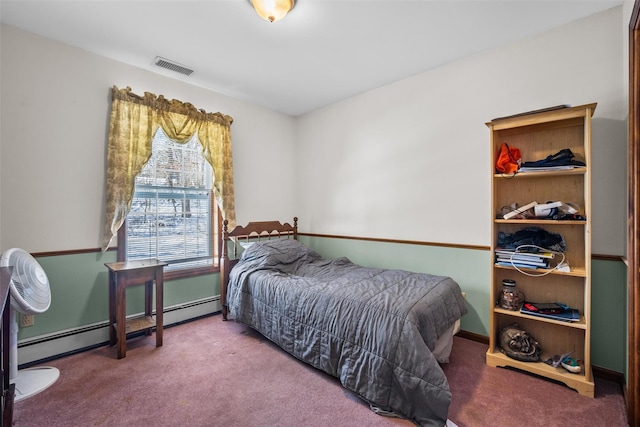 bedroom with visible vents, baseboards, baseboard heating, and carpet floors