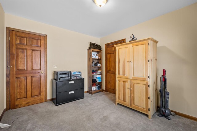 interior space featuring light colored carpet and baseboards