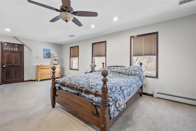 bedroom with a baseboard radiator, multiple windows, light colored carpet, and recessed lighting