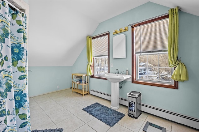 full bathroom with tile patterned flooring, a baseboard heating unit, and vaulted ceiling