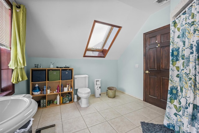 full bathroom with tile patterned flooring, toilet, visible vents, lofted ceiling with skylight, and a sink