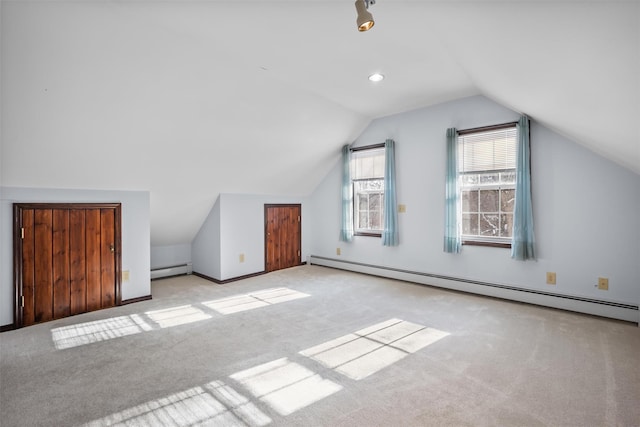 bonus room featuring carpet, baseboard heating, baseboards, and lofted ceiling