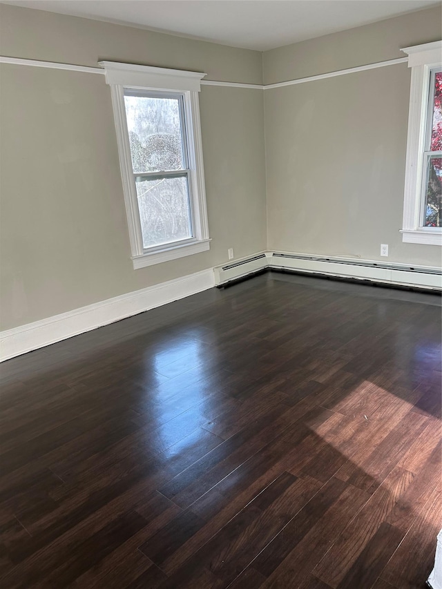 spare room featuring hardwood / wood-style floors and plenty of natural light