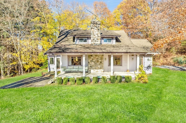 back of house with a lawn