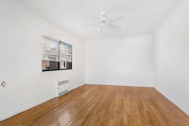 spare room with light hardwood / wood-style flooring, radiator, crown molding, and ceiling fan