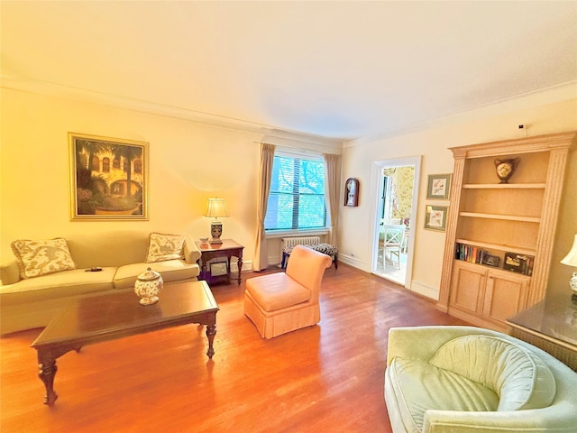 living room with hardwood / wood-style floors and ornamental molding