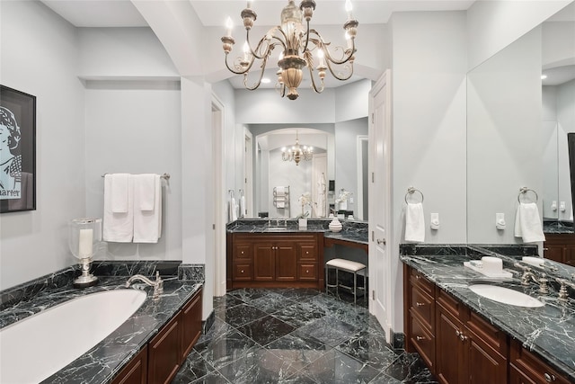 bathroom featuring a notable chandelier, a tub to relax in, and vanity