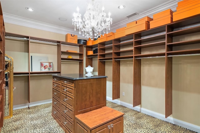 spacious closet featuring an inviting chandelier