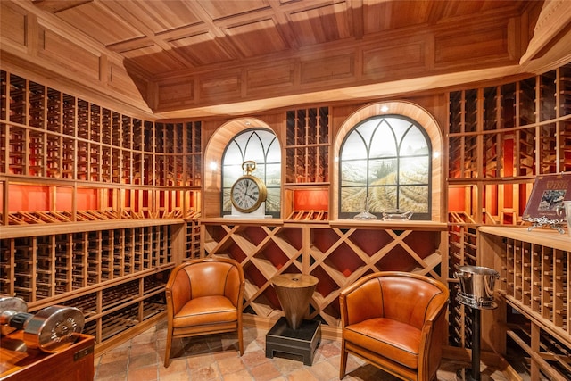 wine cellar featuring wood walls, wooden ceiling, and coffered ceiling