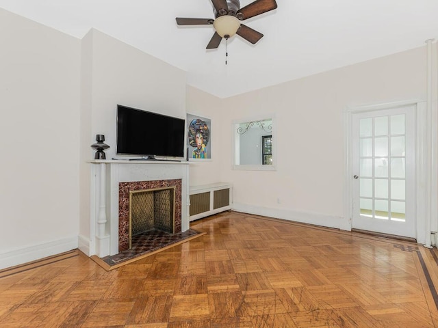 unfurnished living room with a wealth of natural light, light parquet flooring, and ceiling fan