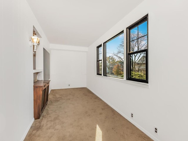 unfurnished living room featuring light colored carpet