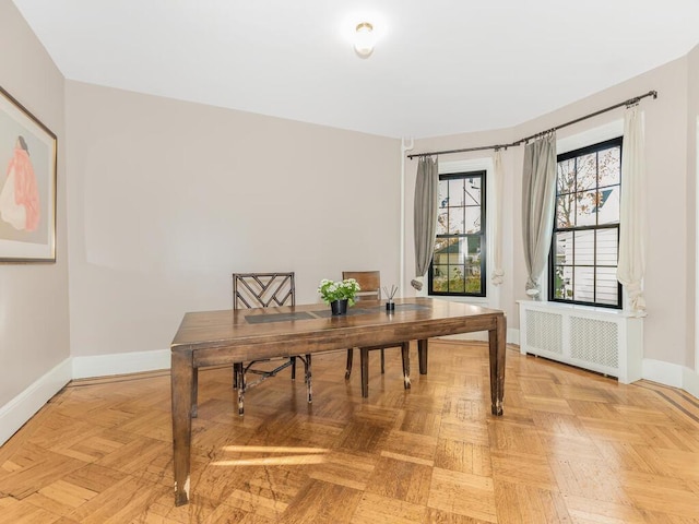 office space featuring radiator and light parquet flooring