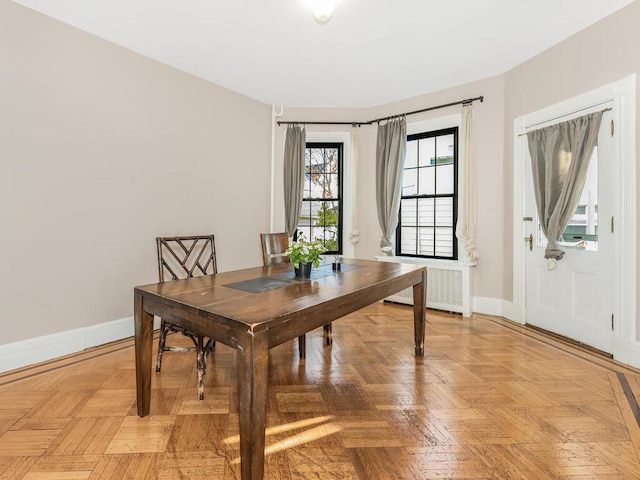 dining room with radiator heating unit and light parquet floors