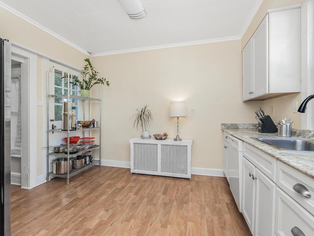 kitchen featuring white cabinets, white dishwasher, light hardwood / wood-style flooring, and ornamental molding