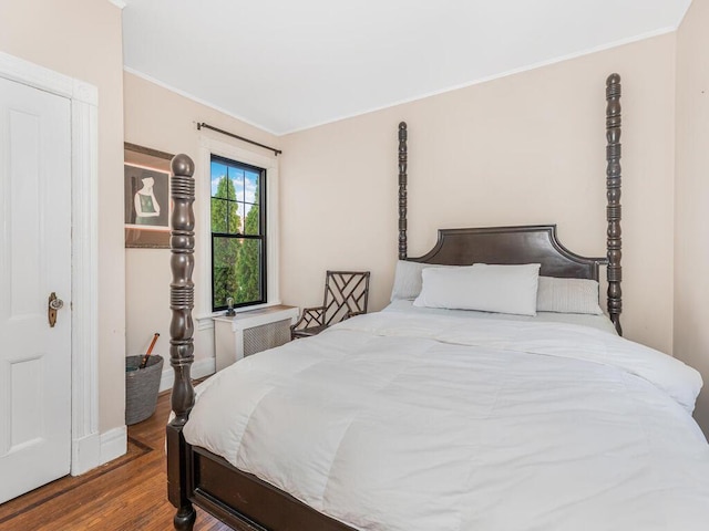 bedroom featuring crown molding and wood-type flooring