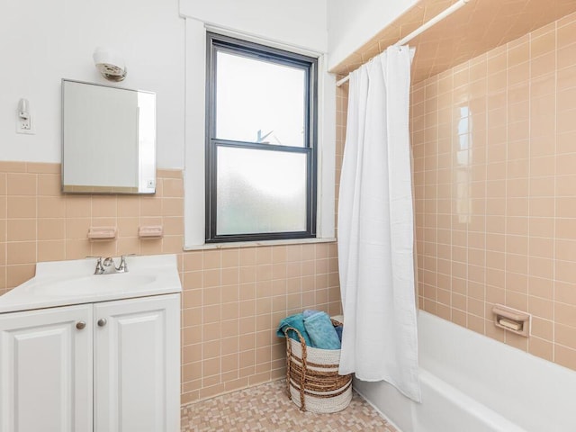 bathroom featuring vanity, tile patterned floors, tile walls, and shower / bath combo with shower curtain