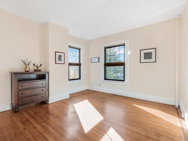 unfurnished room with hardwood / wood-style floors