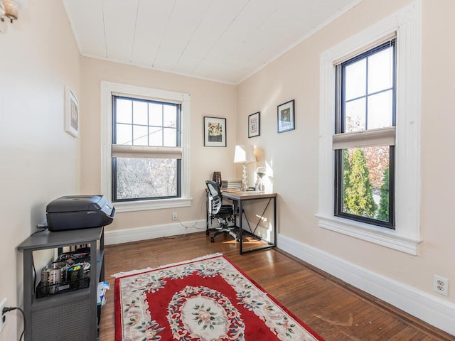 office featuring crown molding, a healthy amount of sunlight, and dark hardwood / wood-style floors